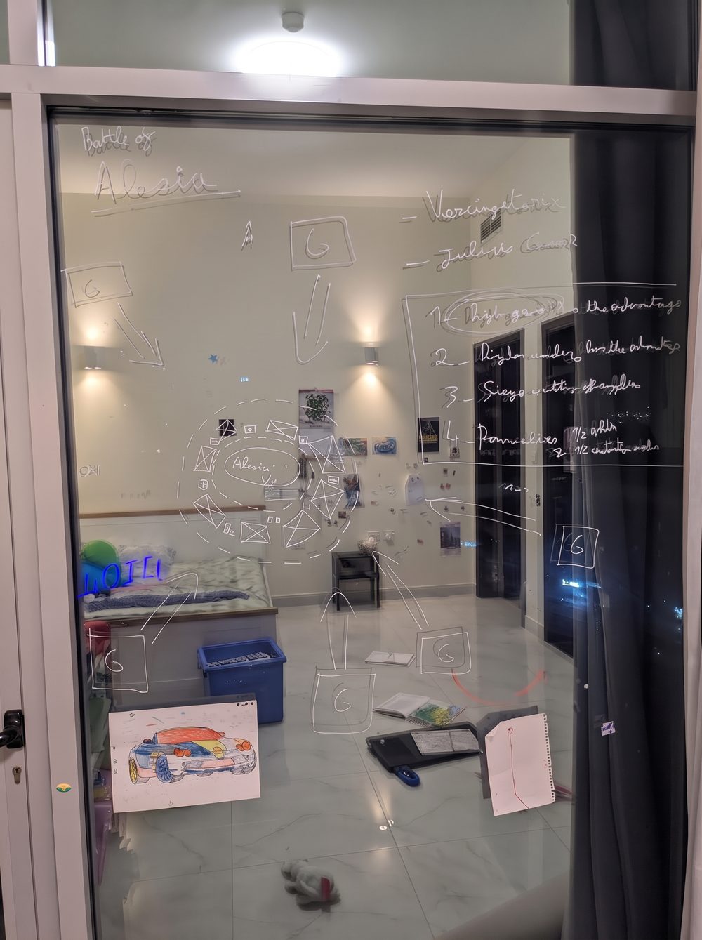 The Battle of Alesia drawn in chalk marker on a window: Caesar's double wall around the town, with arrows for the armies coming in from outside.